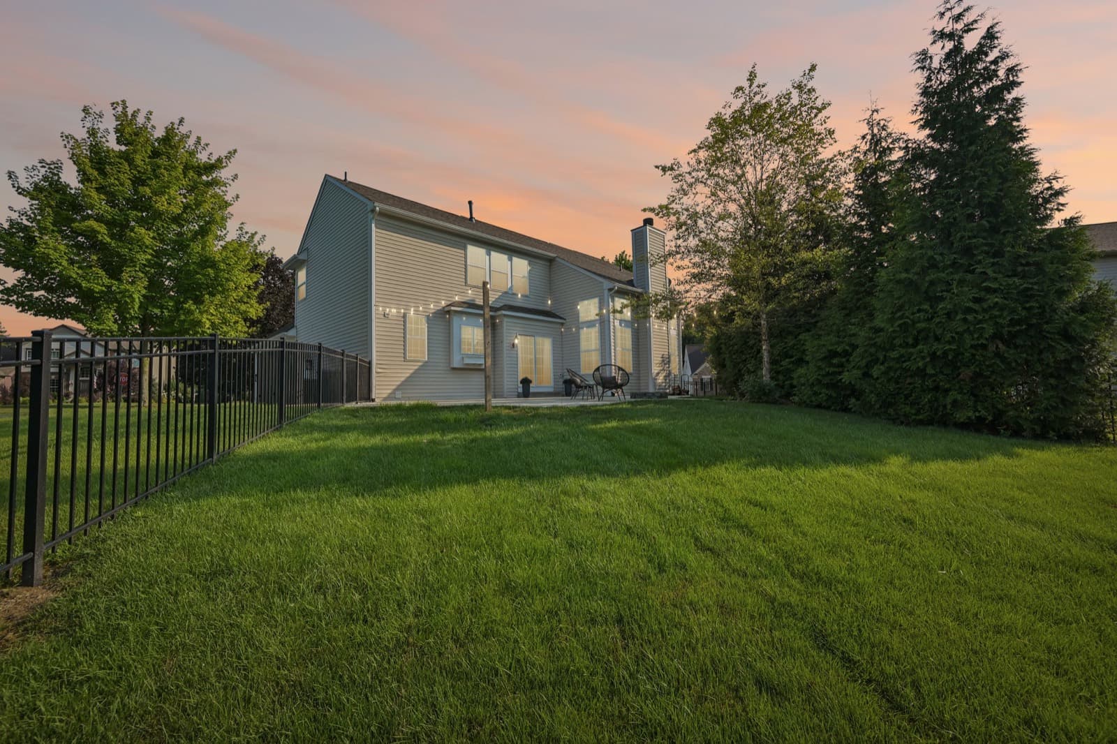 Fully fenced backyard at twilight